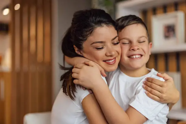 Smiling family in a hug, mother and young son.