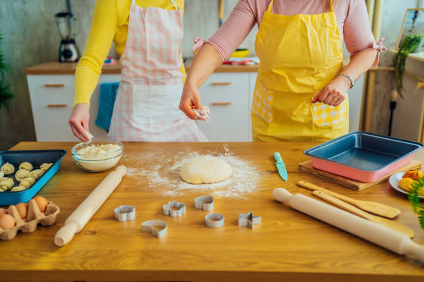 istock Mother and daughter kneading dough 1390245295