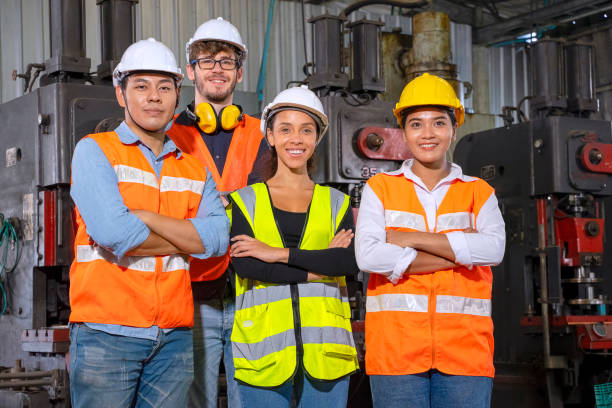 istock Blue collar worker with co worker at factory. 1390245660