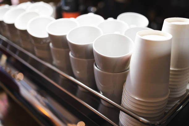 Many stacked in rows of empty clean white cups for tea or coffee