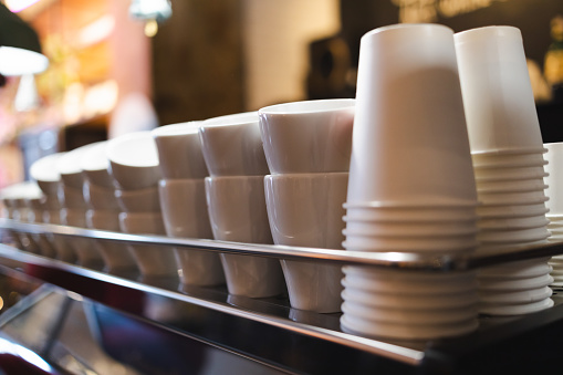 Lot of drinking coffee cups in piles.