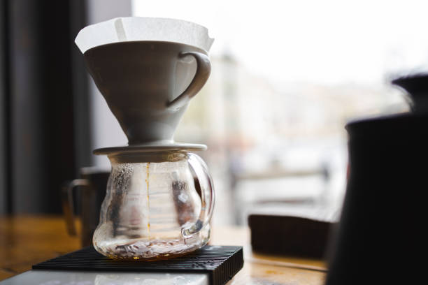 istock Brewing coffee with a filter dripper. Coffee dripping through a paper filter. Alternative way to make coffee. 1390250761