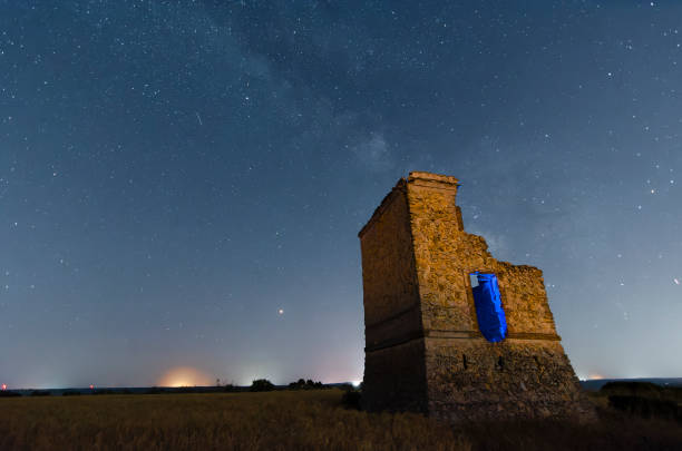 istock Illuminated tower next to a night sky with the milky way and bright stars 1390251413