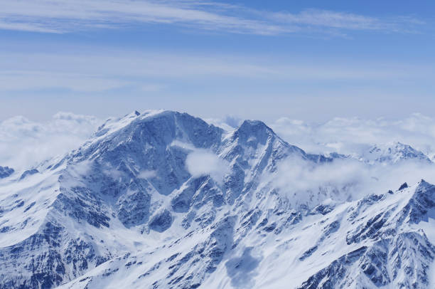 istock Panoramic view on snow mountain peak with clouds and blue sky, Elbrus 1390251535