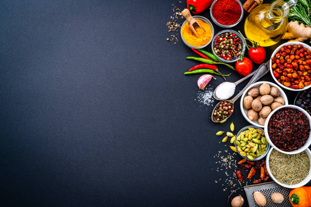 istock Cooking and seasoning ingredients frame on dark background. Copy space 1390256994
