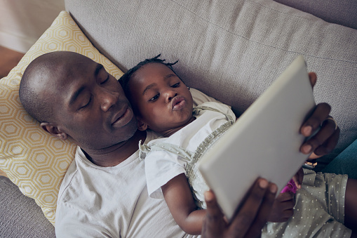Shot of a father and daughter using a digital tablet together at home