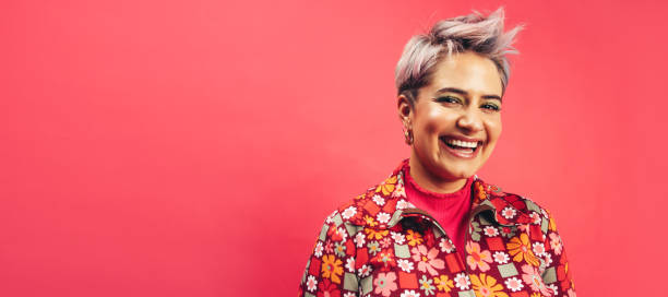 istock Happy hipster woman smiling at the camera in a studio 1390257075