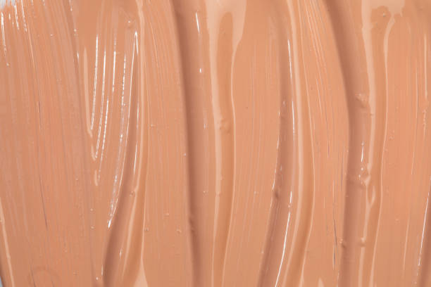 istock Beige nude liquid foundation texture, concealer smear smudge drop. Closeup macro. Cosmetic tonal makeup moisturizer, bb cream swatch sample. 1390258880