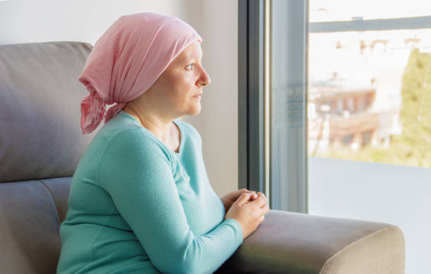 istock woman with cancer in head scarf 1390260270