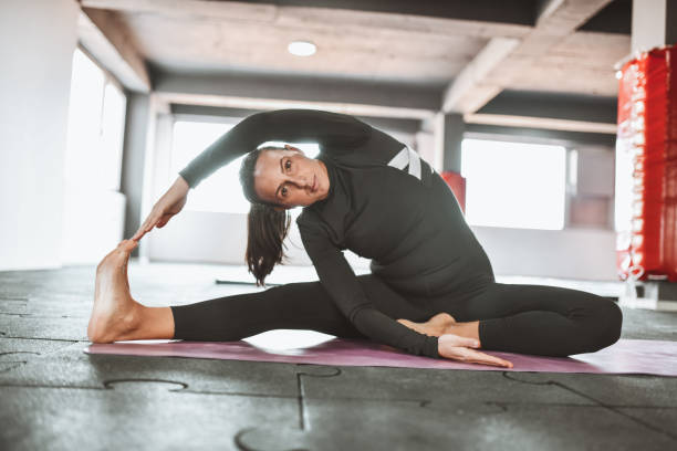istock Pregnant Female Showing Flexibility In Gym While Practicing Yoga 1390261718