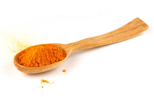 istock Turmeric Curcuma spice in a wooden spoon 1390263728