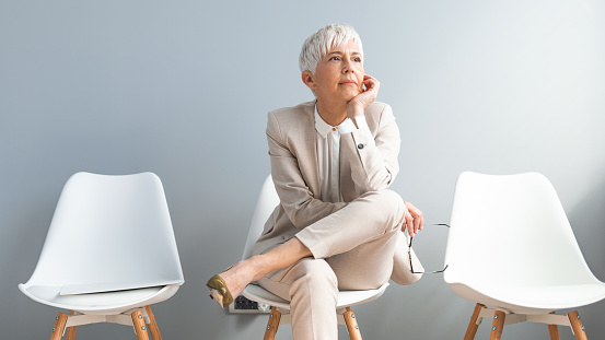 Shot of a mature businesswoman sitting in a waiting room