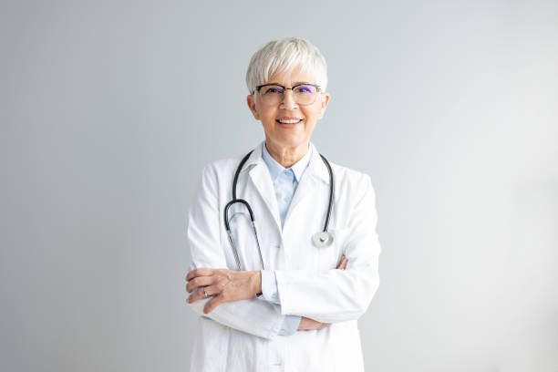 portrait of a confident mature businesswoman - senior adult hospital uniform gray hair imagens e fotografias de stock