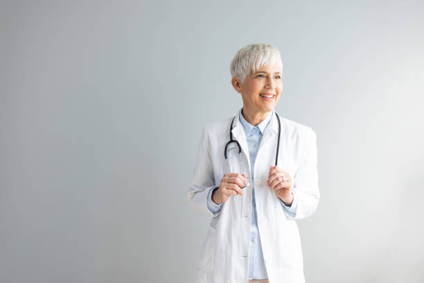 istock Confident smiling female doctor, looking away. 1390265504