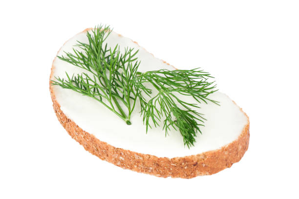 slice of white bread with melted cheese and dill isolated