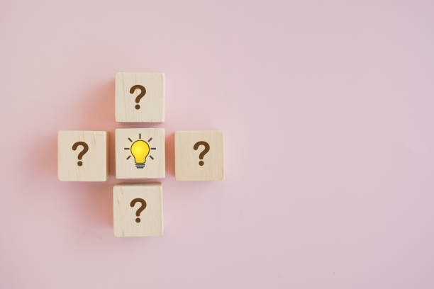 istock bright lightbulb icon among question mark on wooden cube block , Conceptual of creative idea and innovation, leadership, smart employee 1390267312