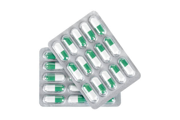 istock medical pills capsules white with green isolated 1390267389