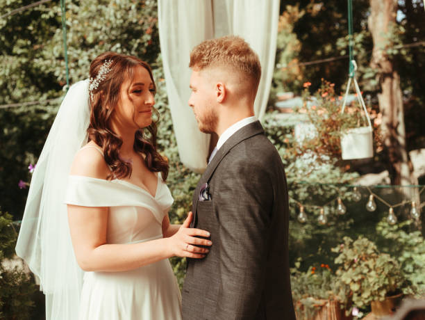 istock bride helps groom to wear a tie grain effect 1390267400