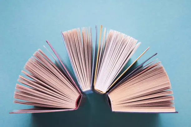 Photo of Several paper books on a blue background. International book day