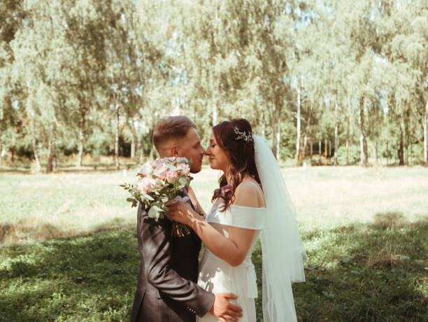 istock Happy wedding couple walking in a botanical park grain effect authentic 1390270097