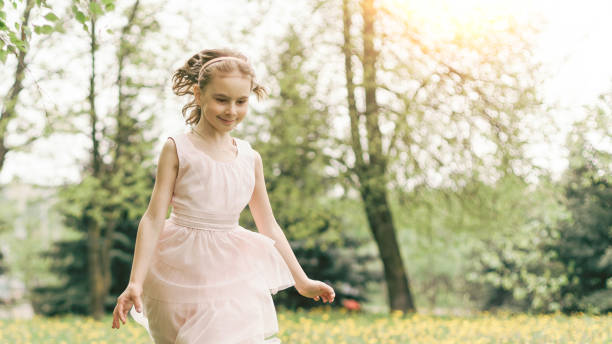 istock girl runs through dandelions in the park 1390271231