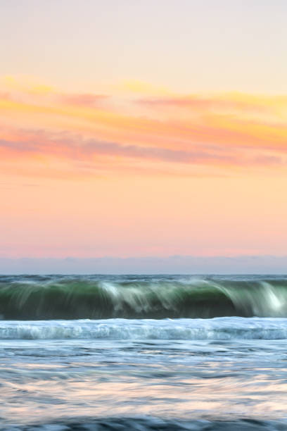 istock Motion blur in crashing waves under a beautifully colorful sunset sky. 1390275016