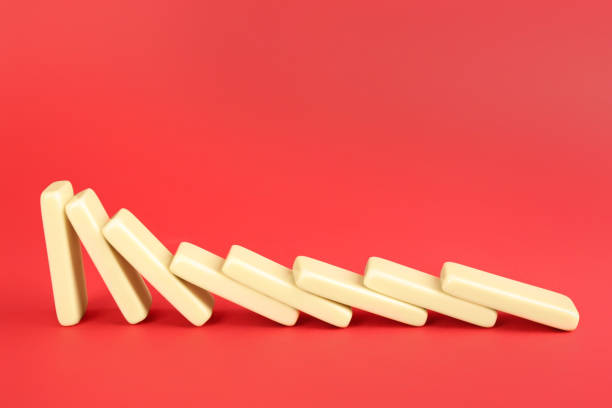 istock White domino tiles falling on red background. Space for text 1390275349