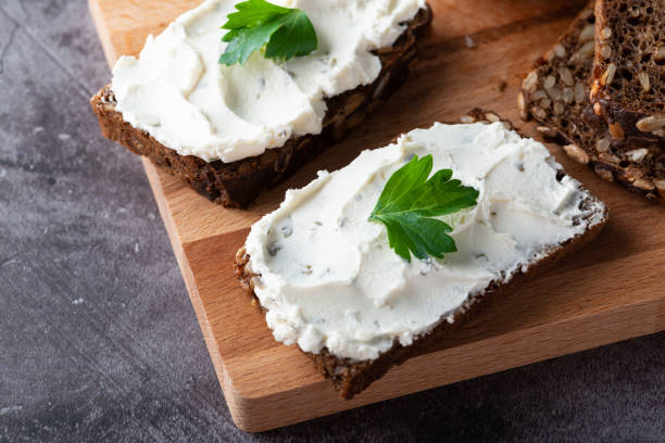 istock Rye bread with cream cheese on grey table. Whole grain rye bread with seeds 1390277351