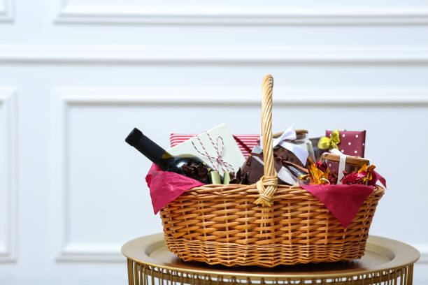 istock Gift set in wicker basket on golden table near white wall 1390277444