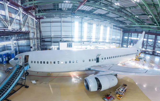 istock White passenger airliner in the hangar. Airplane under maintenance 1390279129