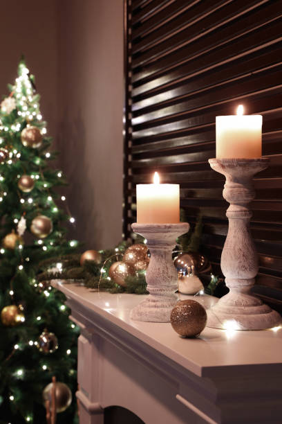 istock Burning candles and Christmas decor on white mantelpiece 1390279913