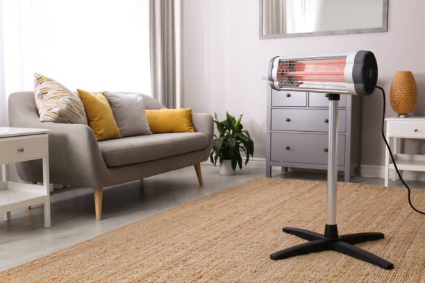modern electric infrared heater in living room - appliance living room domestic room lifestyles imagens e fotografias de stock