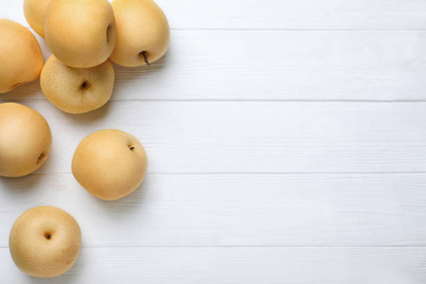 istock Ripe apple pears on white wooden table, flat lay. Space for text 1390279967