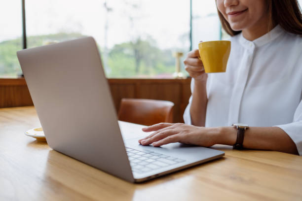 istock Closeup image of a businesswoman drinking coffee while working on laptop computer 1390282032