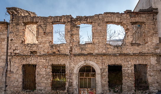 A derelict bomb damaged ruin still remaining from the war in Bosnia on the city of Mostar, Bosnia & Herzegovina