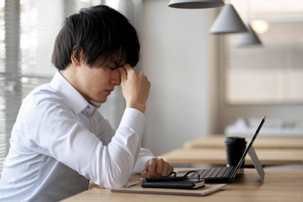 Asian businessman tired of computer work