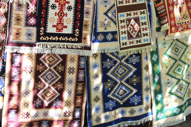 istock Hand-made carpets hanging in street market. 1390287150