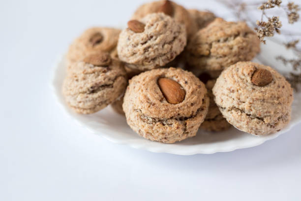 Almendrados, dumplings or typical biscuits made from almonds, sugar and egg yolk. Almond cakes on white background.