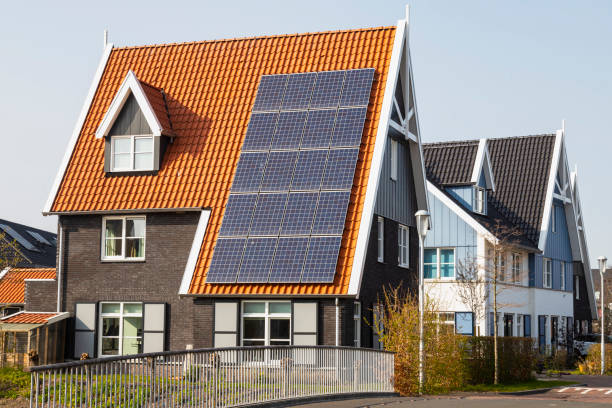 istock Solar panels on a new house with red roof. 1390290147