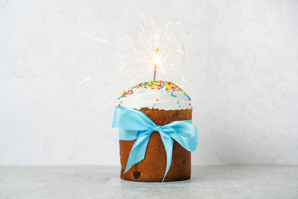 istock Easter cake with baw and sparkler on concrete background, easter food. minimal concept 1390290274