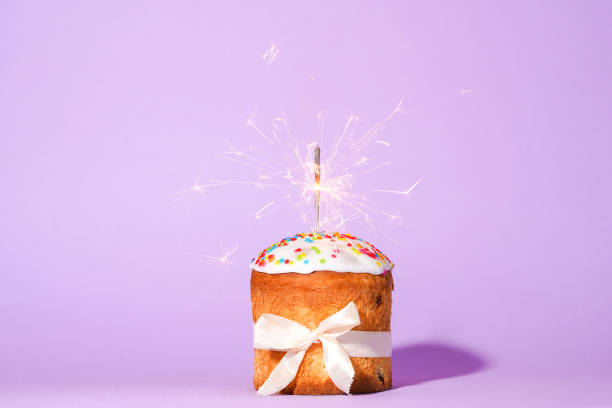 istock Easter cake with baw and sparkler on red background, easter food. minimal concept 1390290275