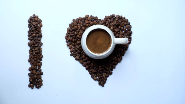 istock a cup of black coffee with a heart shaped coffee bean background 1390295279