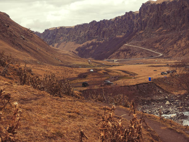 off-road trip to the autumn valley of the caucasus mountains along the river in the gorge - journey camel travel desert imagens e fotografias de stock