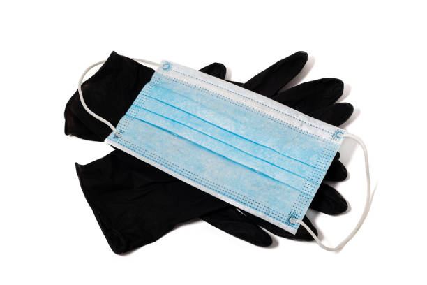 白い背景に薄い青い医療ラテックス手袋と顔シールドのペア。 - surgical glove surgical mask protective glove mask ストックフォトと画像