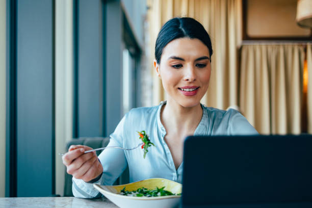 istock Happy Business Woman Using Digital Tablet During Lunch Break 1390298263