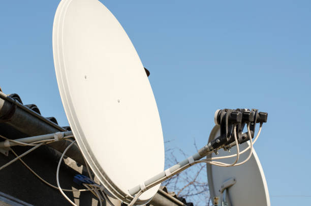 istock Satellite TV antenna on a private house, close-up 1390299858