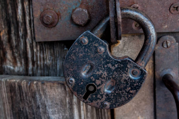 istock Barn old rusty lock on the door. The idea of a ban 1390300105