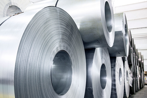 Large rolls of sheet aluminum in a metal manufacturing facility