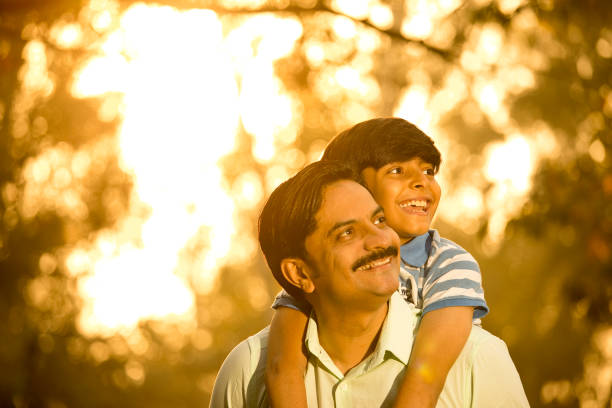 istock Cheerful boy admiring nature with his father 1390300395