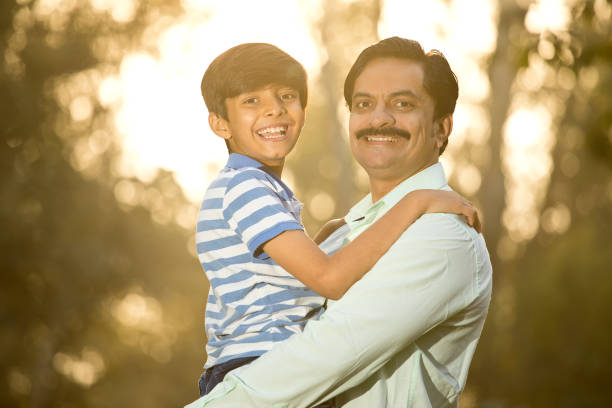 istock Cheerful boy admiring nature with his father 1390300537